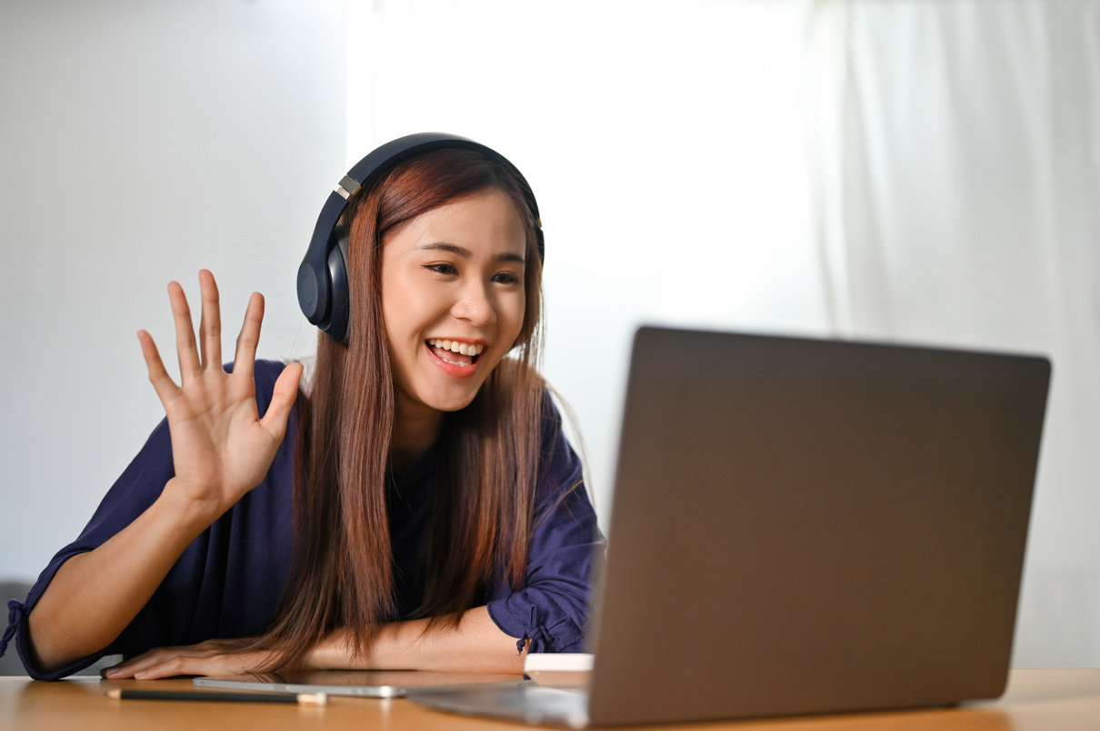 Cheerful Asian Female Tutor Is Tutoring Her Students on Online M